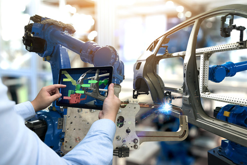 Industry 4.0 concept . Man hand holding tablet with performance